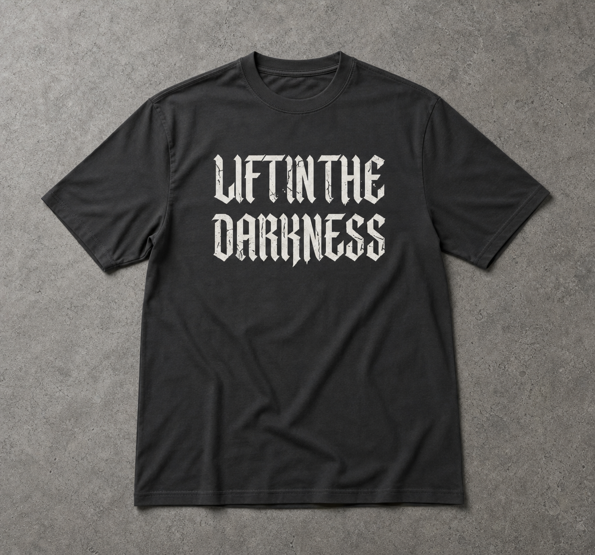 Black t-shirt with 'LIFT IN THE DARKNESS' text on a gray background