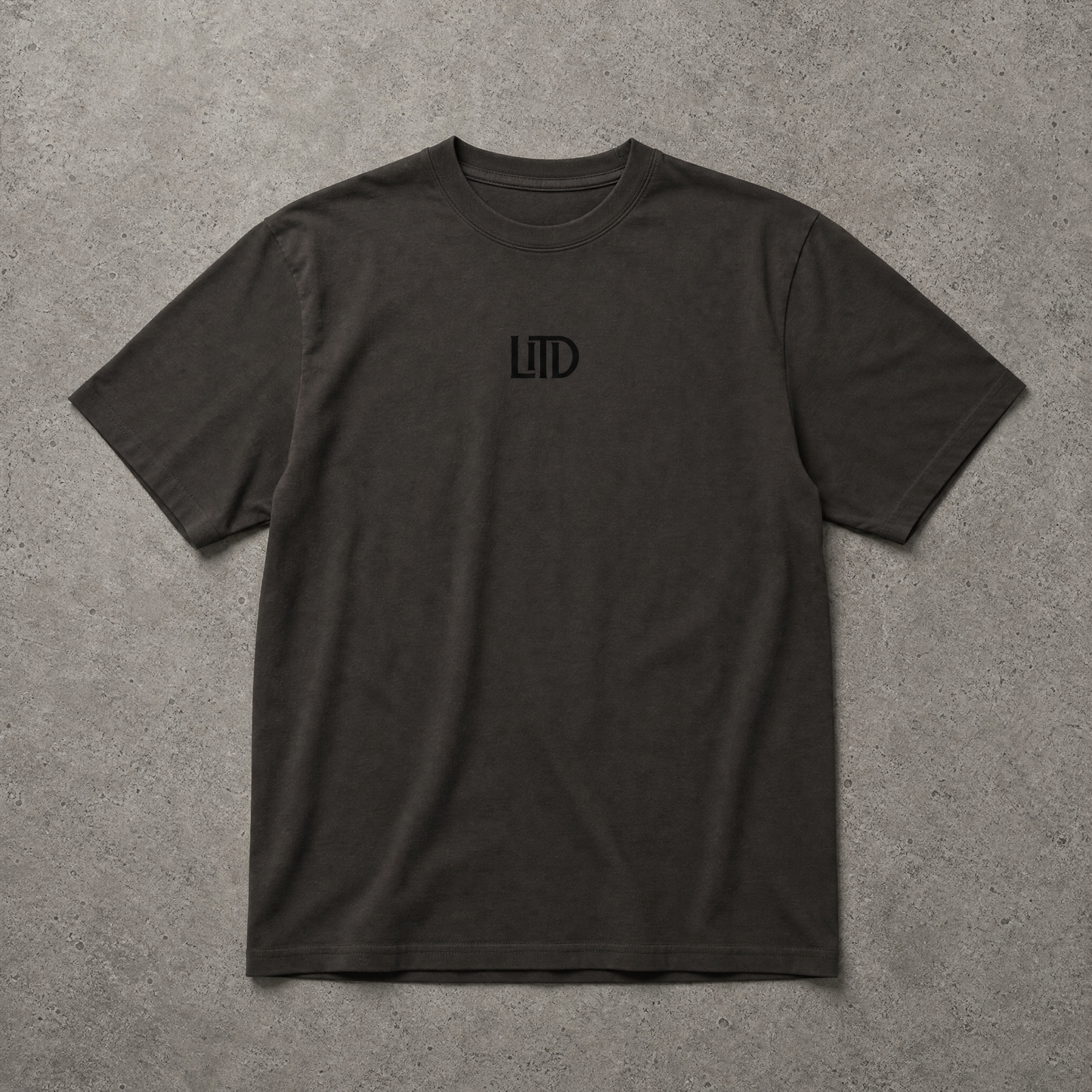 Black t-shirt with a logo on a gray surface