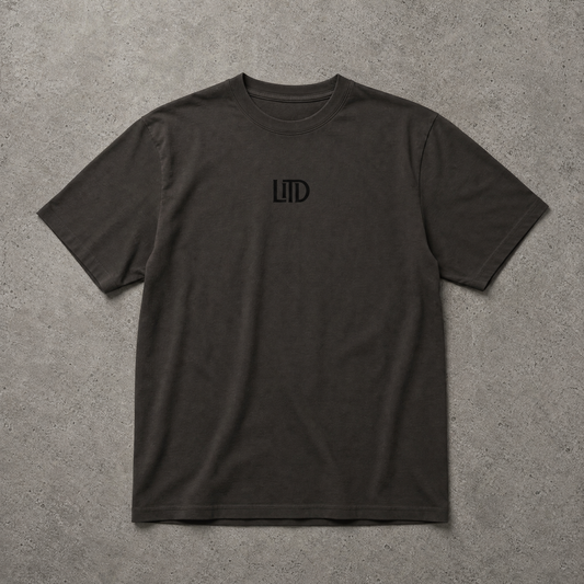 Black t-shirt with a logo on a gray surface