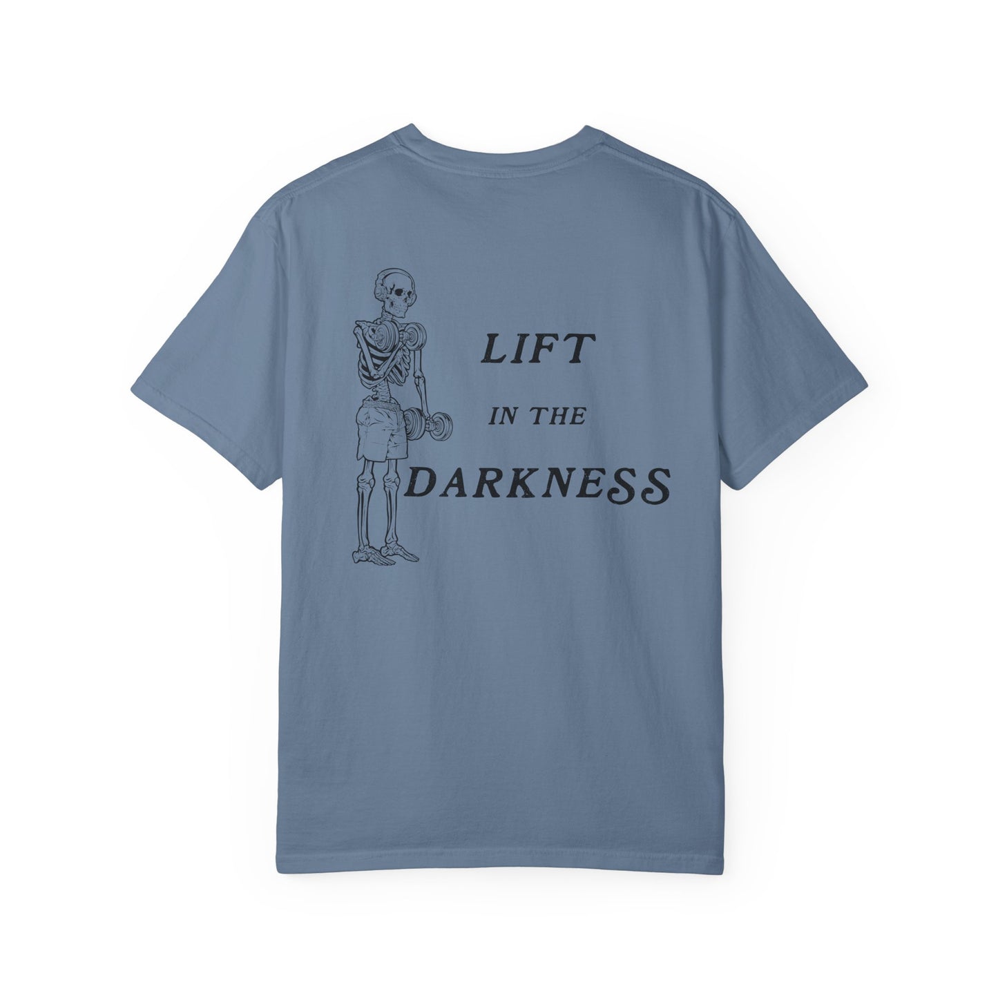 Blue t-shirt with skeleton graphic and text 'Lift in the Darkness' on a white background