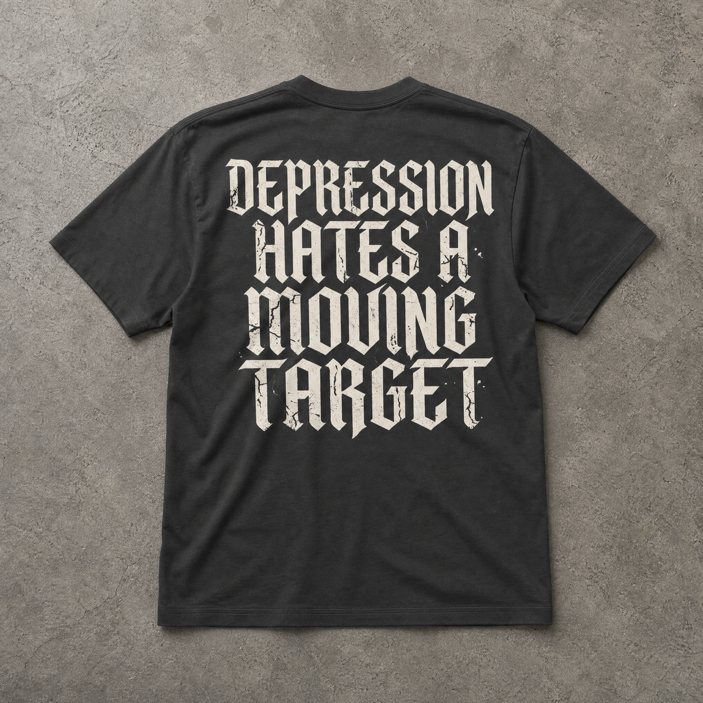 Black t-shirt with white text on a gray concrete background