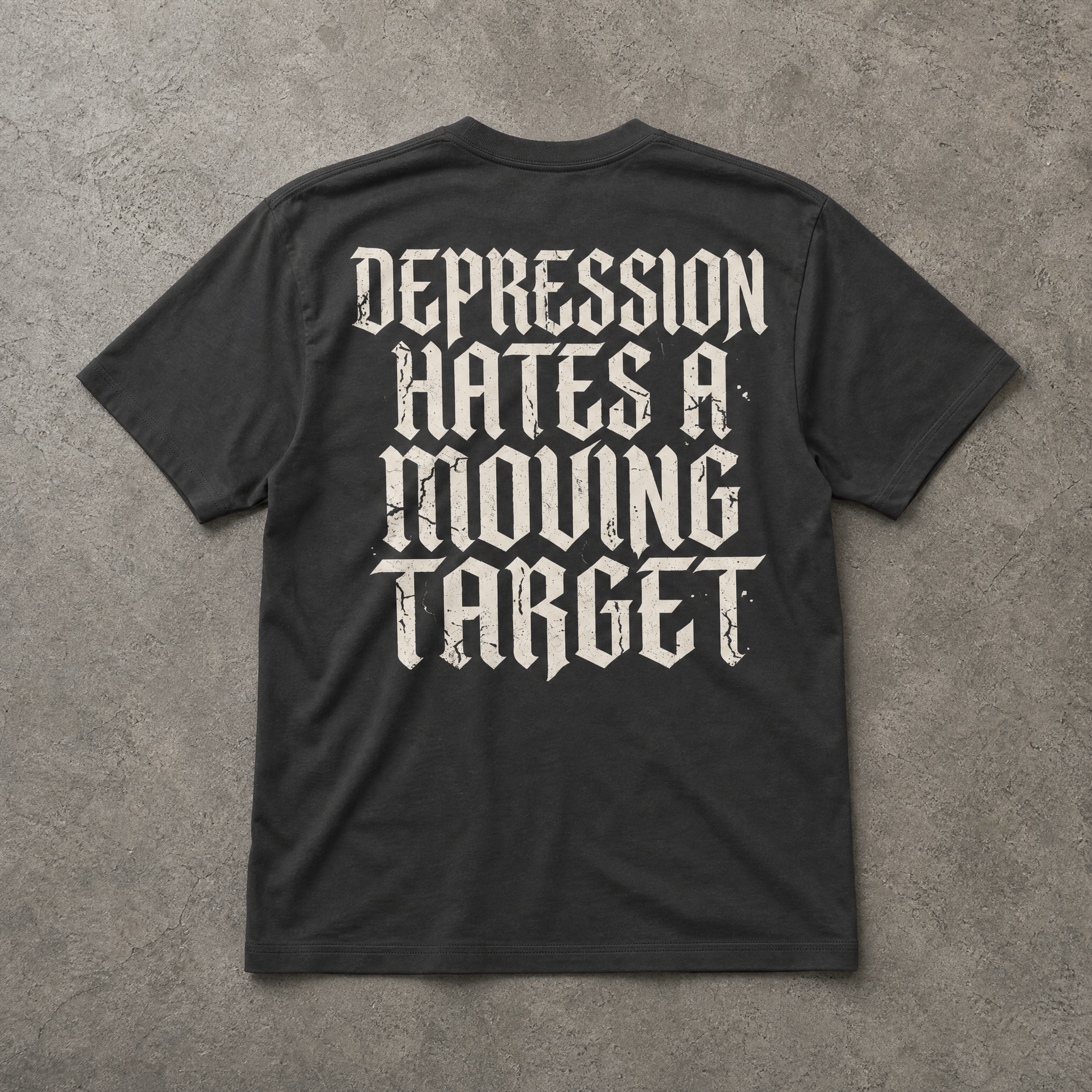 Black t-shirt with white text on a gray concrete background