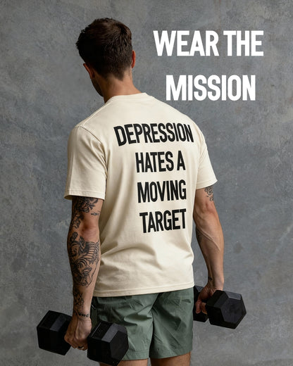 Person wearing a t-shirt with motivational text, holding dumbbells against a gray background.