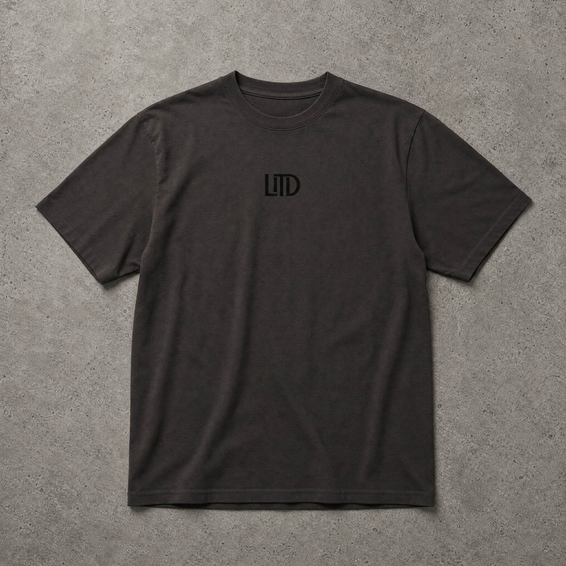 Black t-shirt with a logo on a gray surface
