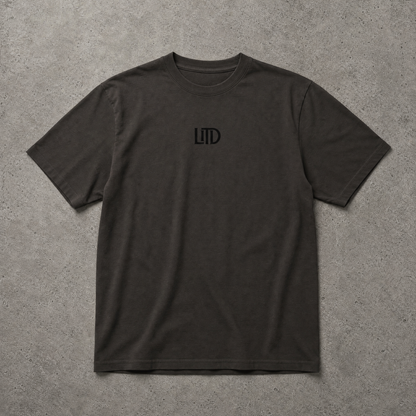 Black t-shirt with a logo on a gray surface