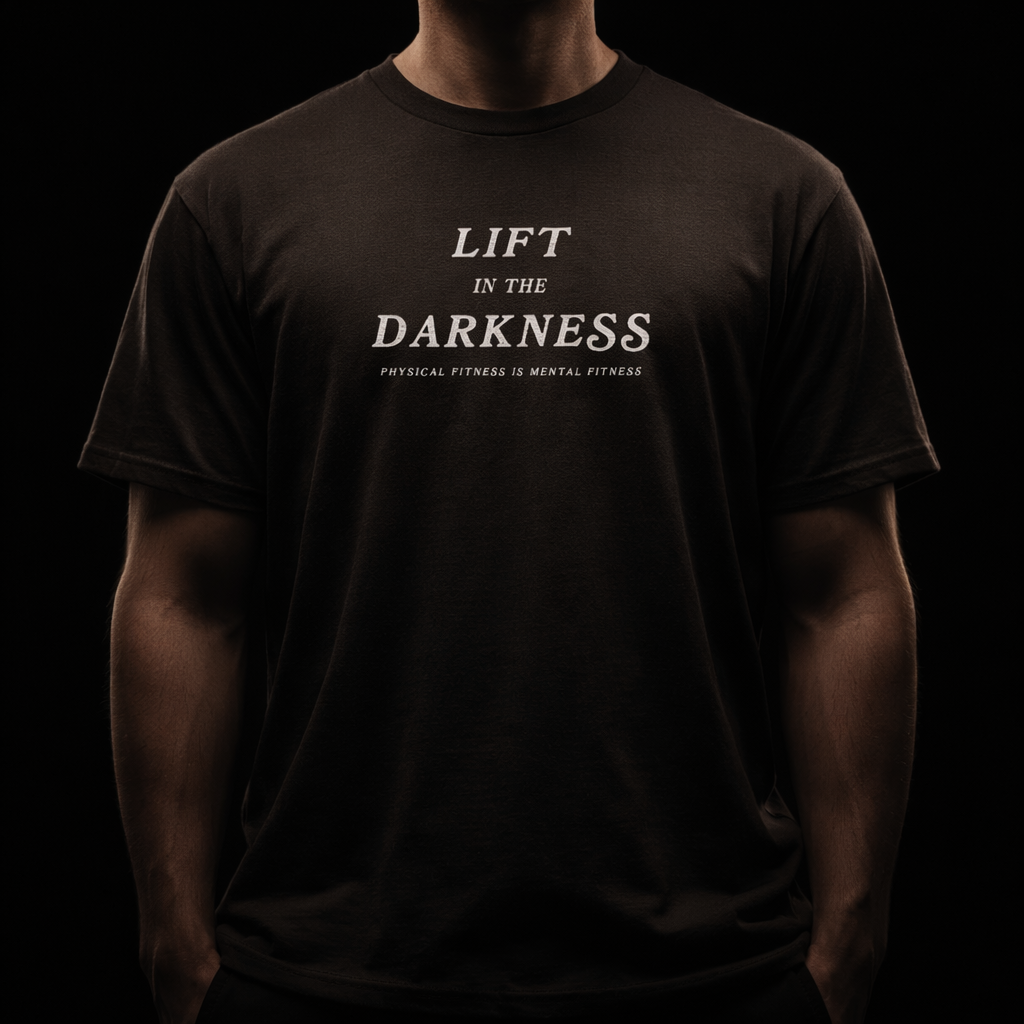 Person wearing a black t-shirt with 'Lift in the Darkness' text on a dark background