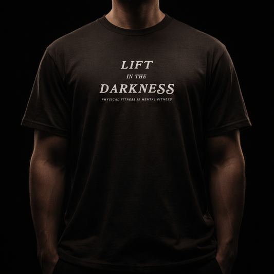 Person wearing a black t-shirt with 'Lift in the Darkness' text on a dark background