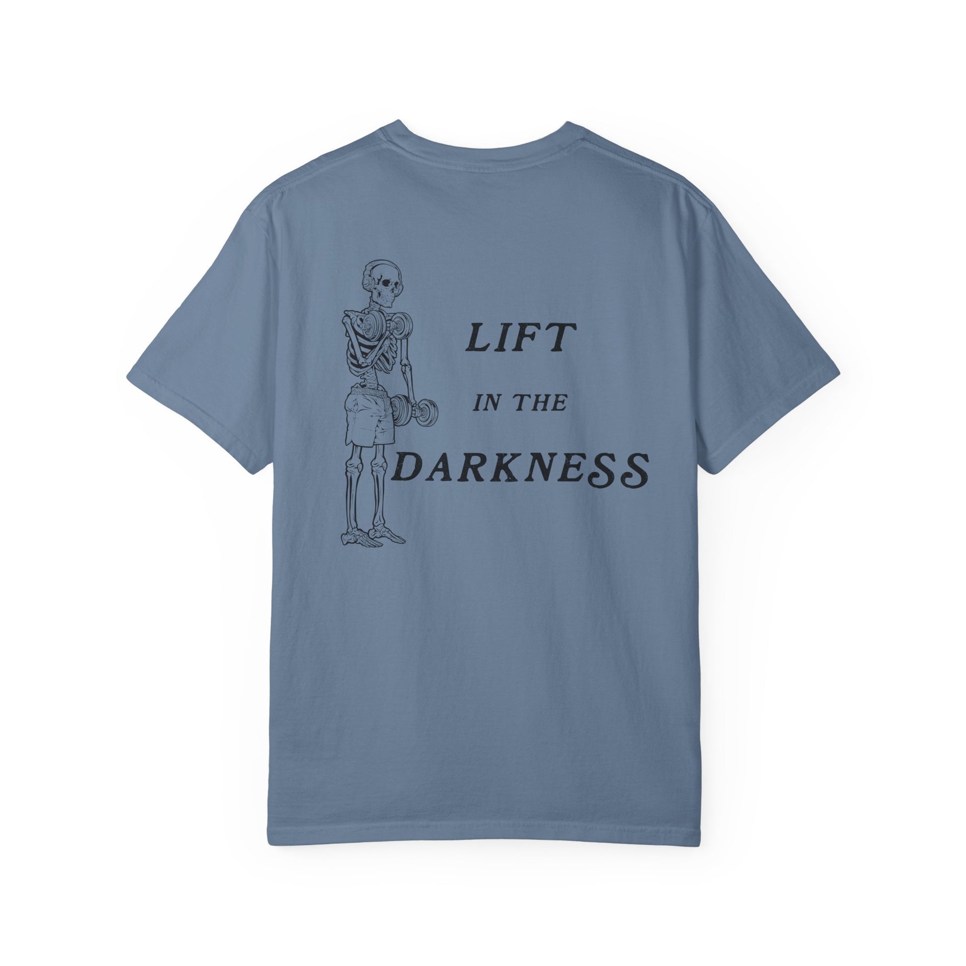 Blue t-shirt with skeleton graphic and text 'Lift in the Darkness' on a white background