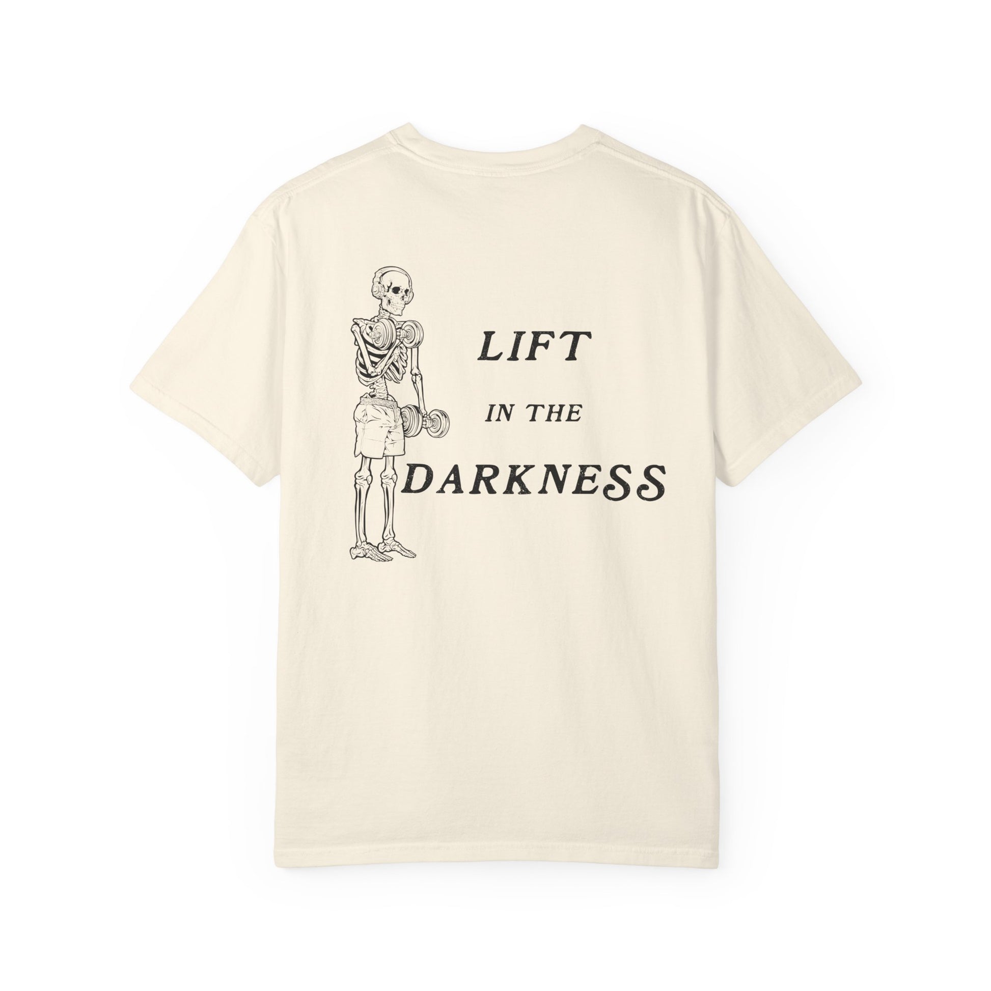 Beige t-shirt with skeleton graphic and text 'Lift in the Darkness' on a white background