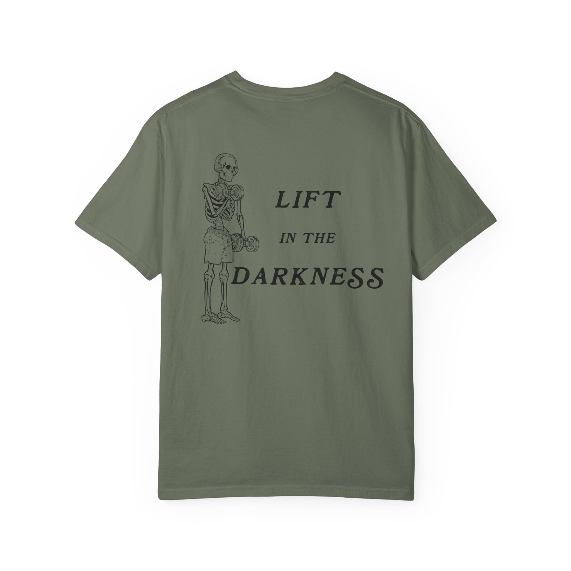 Green t-shirt with skeleton graphic and text 'Lift in the Darkness' on a white background
