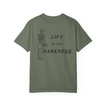 Green t-shirt with skeleton graphic and text 'Lift in the Darkness' on a white background