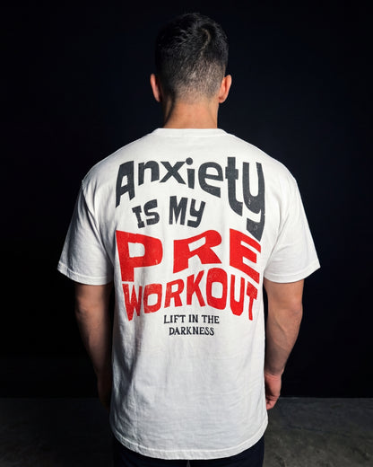 Person wearing a white t-shirt with text on the back against a black background