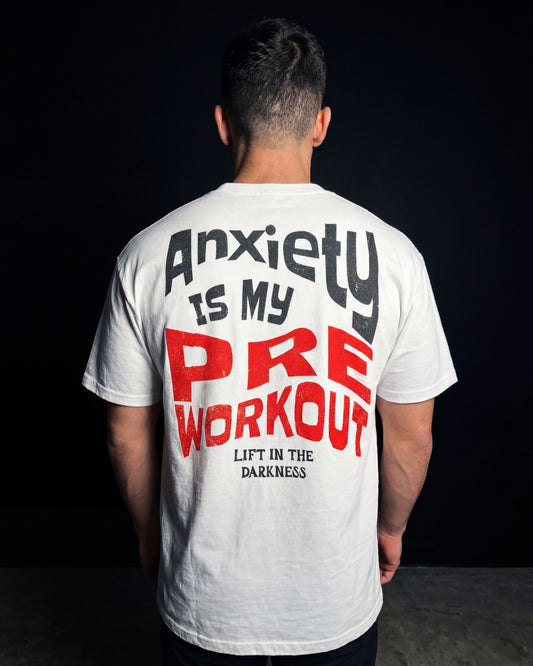 Person wearing a white t-shirt with text on the back against a black background