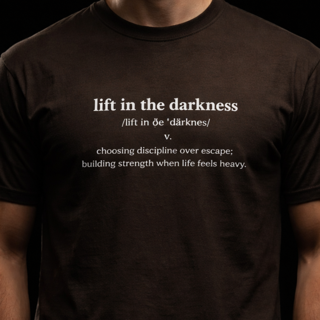Person wearing a black t-shirt with text on a black background