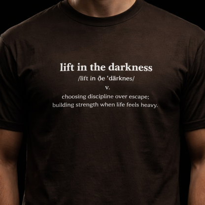 Person wearing a black t-shirt with text on a black background
