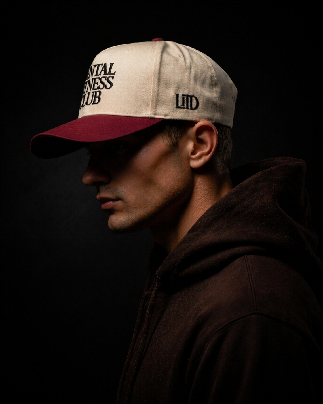 Person wearing a cap with text on a dark background