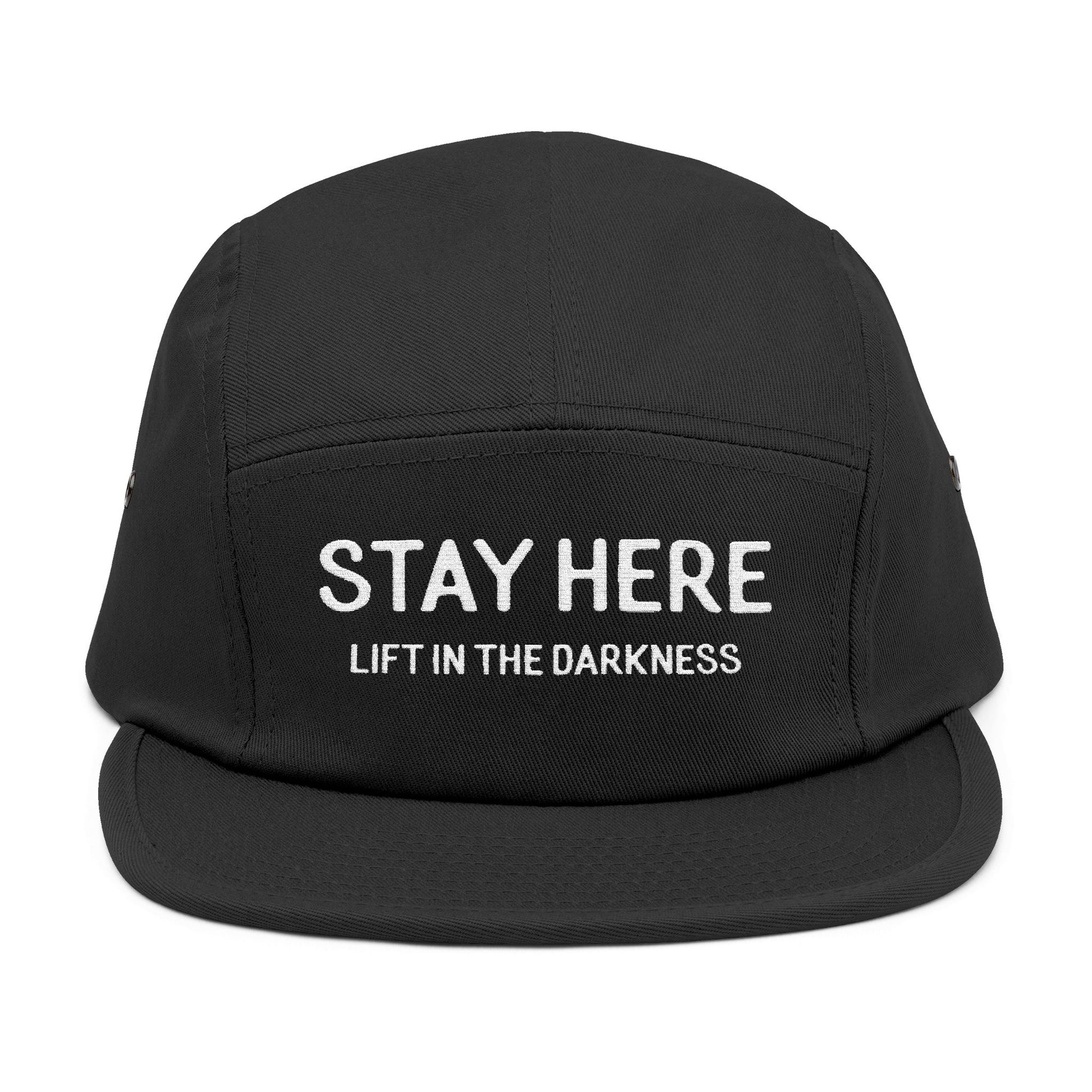Black cap with 'Stay Here Lift in the Darkness' text on a white background