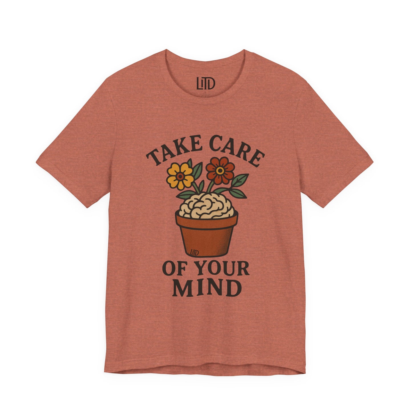 Coral t-shirt with 'Take Care of Your Mind' graphic design on a white background