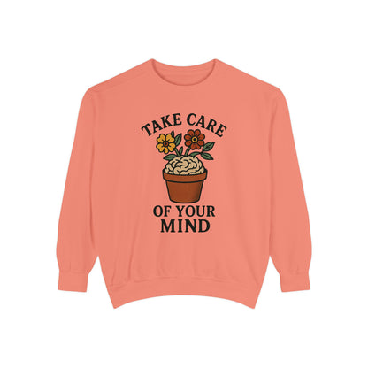 Coral sweatshirt with a plant graphic and text 'Take care of your mind' on a white background