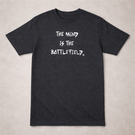 Black t-shirt with white text 'The mind is the battlefield' on a beige background